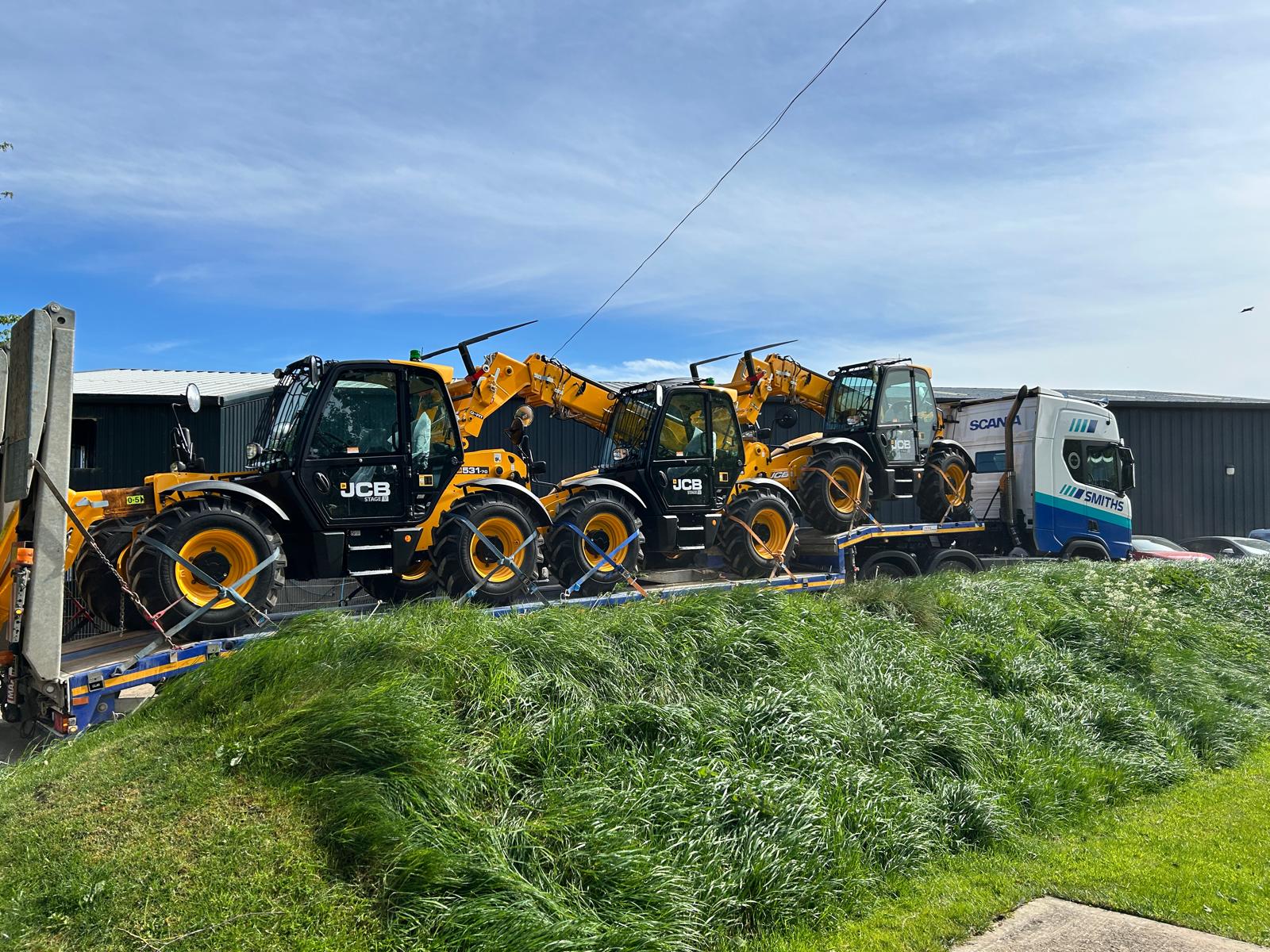 JCB constructions telehandlers loaded on lorry